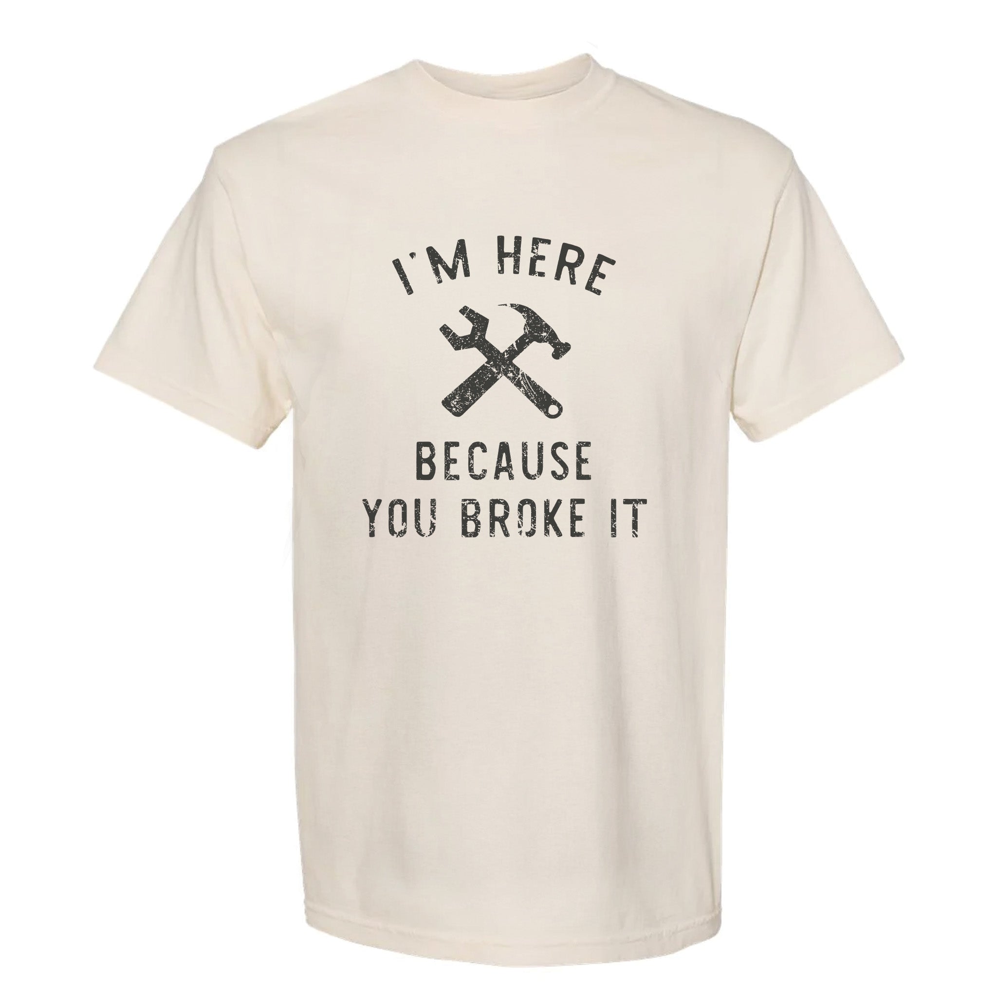 Beige funny graphic t-shirt with text: I'm Here Because You Broke It