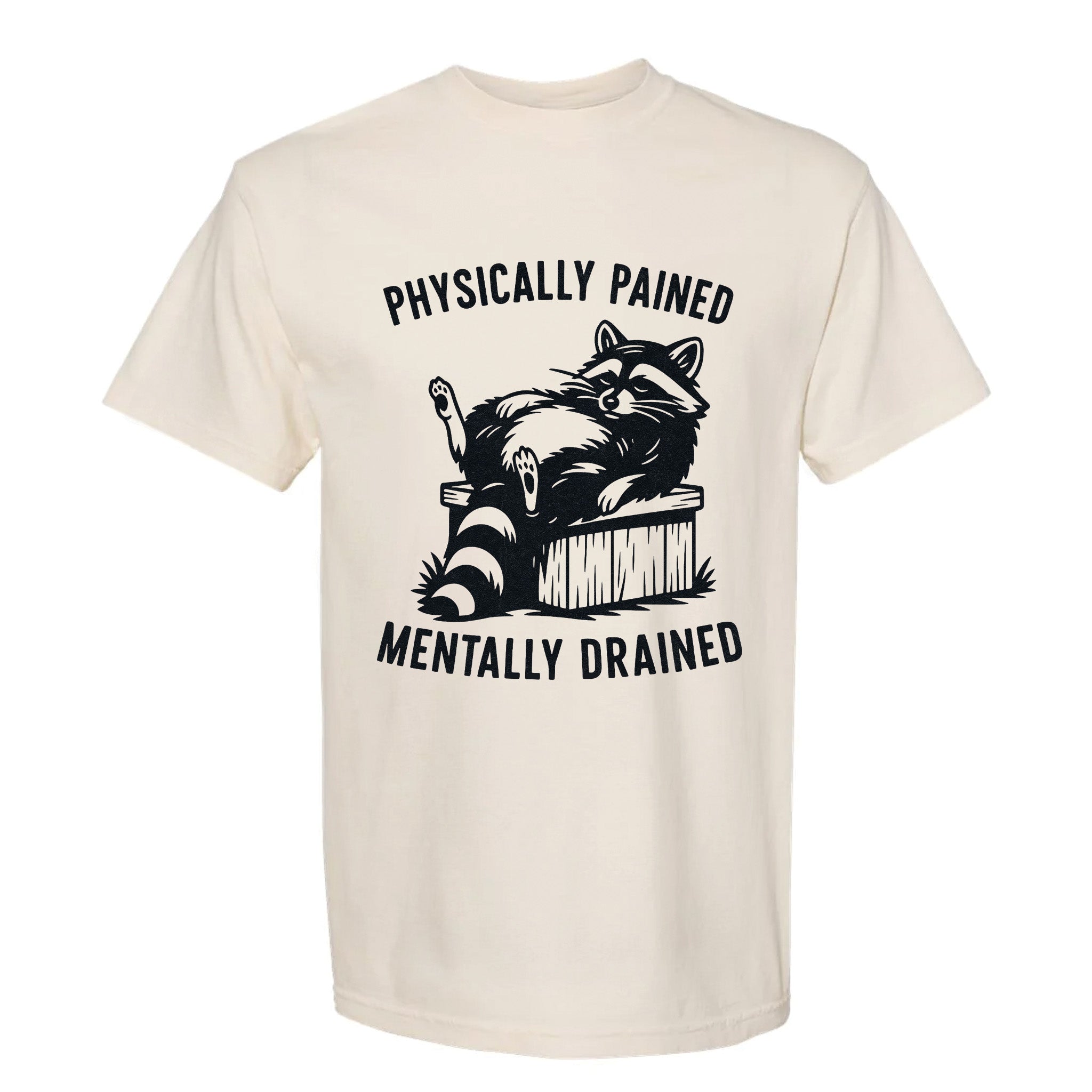 Beige funny graphic t-shirt with a raccoon graphic and text "Physically Pained Mentally Drained".