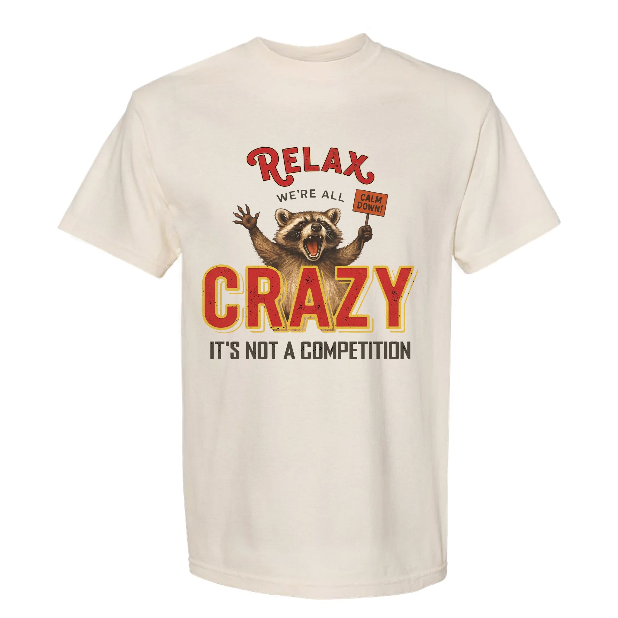 Ivory funny graphic t-shirt with a graphic of a raccoon and text "Relax We're All Crazy It's Not A Competition"