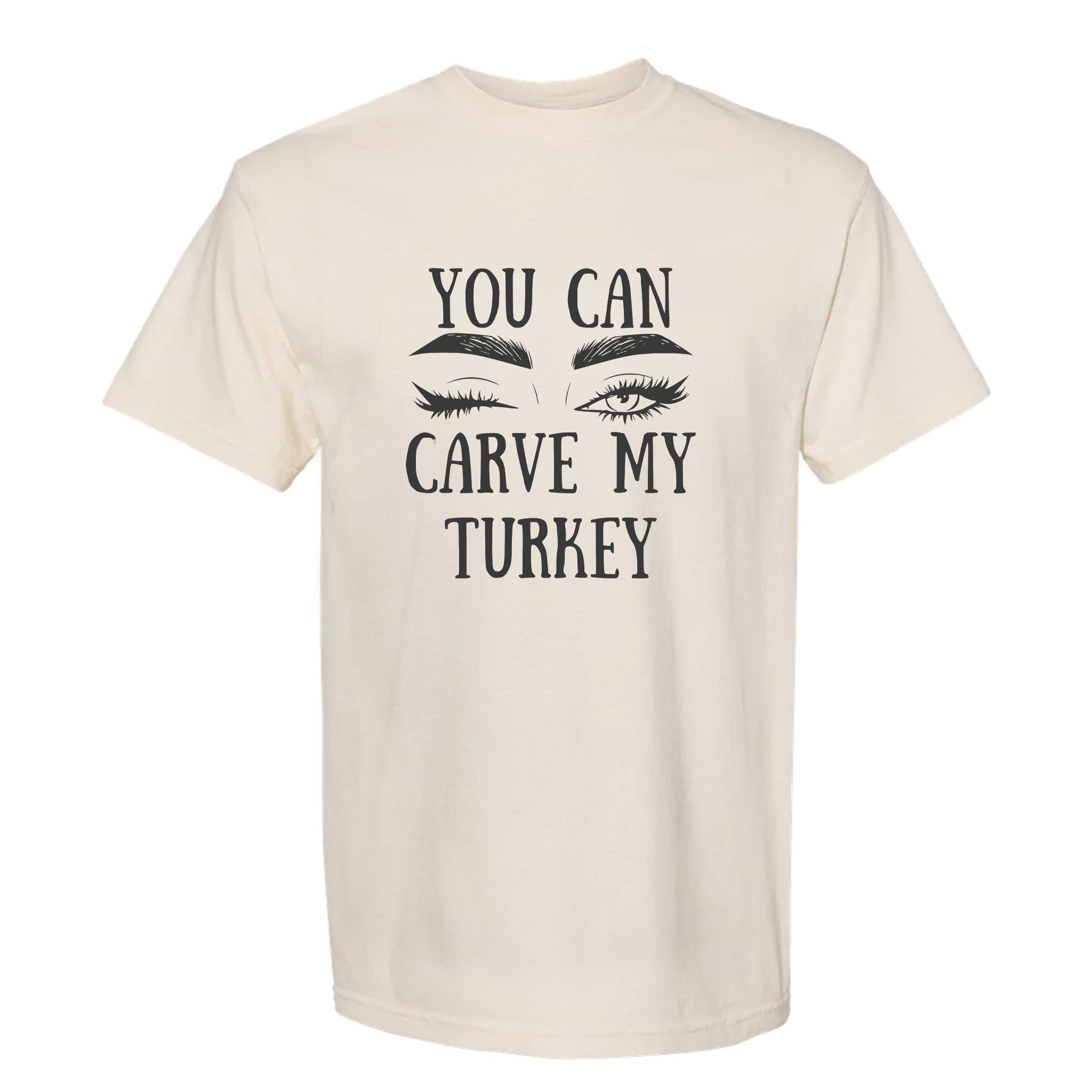 Beige Thanksgiving graphic t-shirt with 'You can carve my Turkey' text and eye makeup graphics on a white background