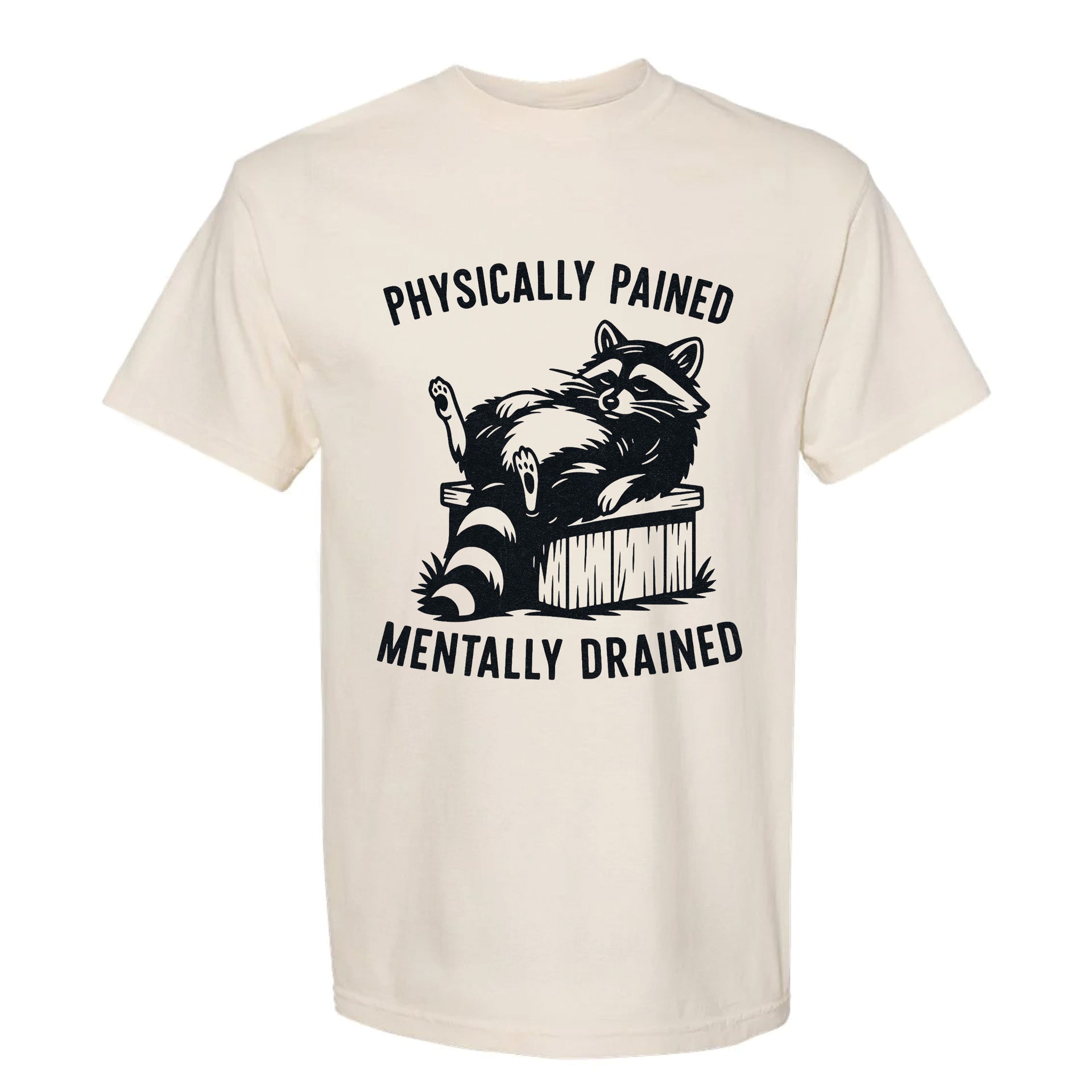 Beige funny graphic t-shirt with a raccoon graphic and text "Physically Pained Mentally Drained".