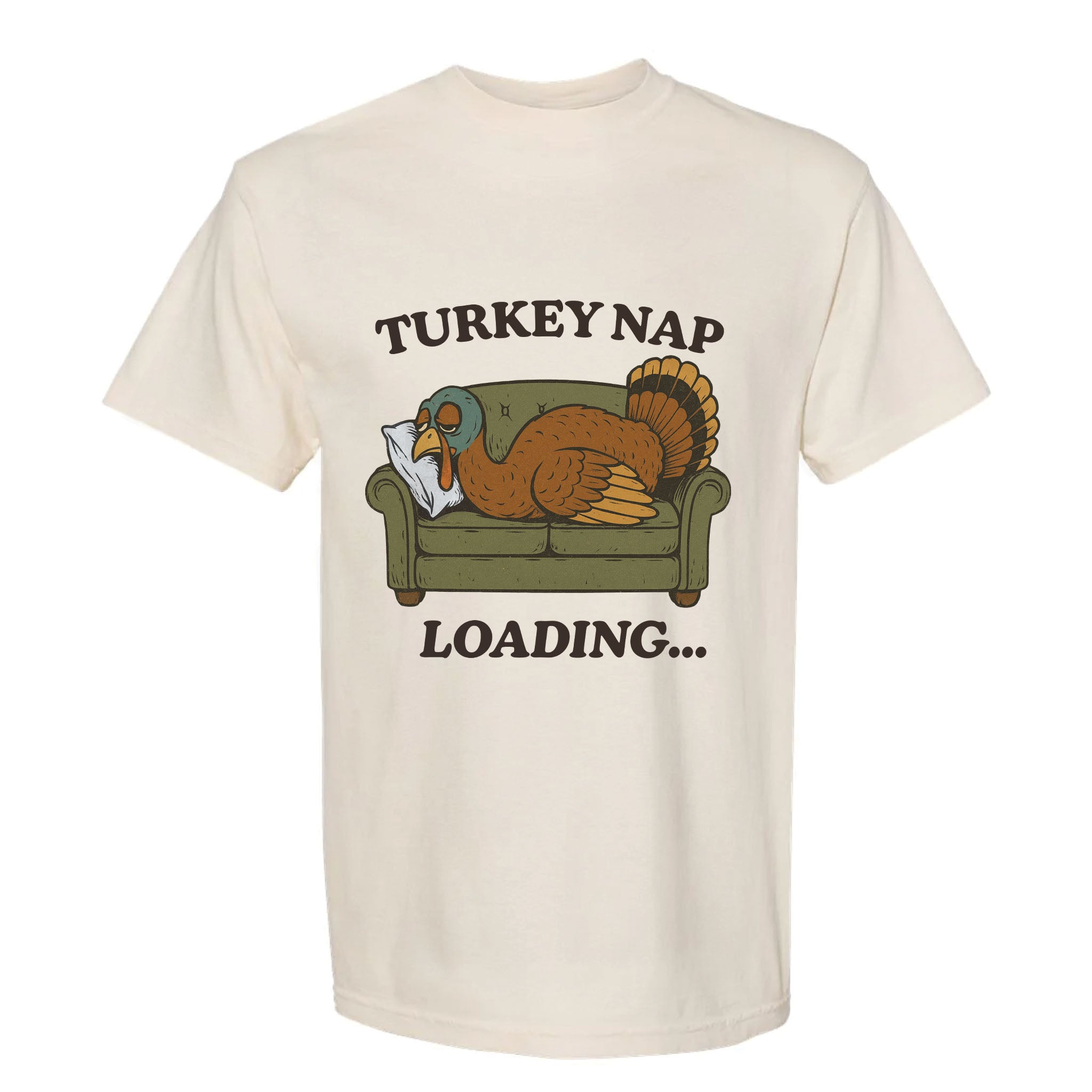 Beige Thanksgiving t-shirt with a graphic of a turkey on a couch and text 'Turkey Nap Loading...' on a white background