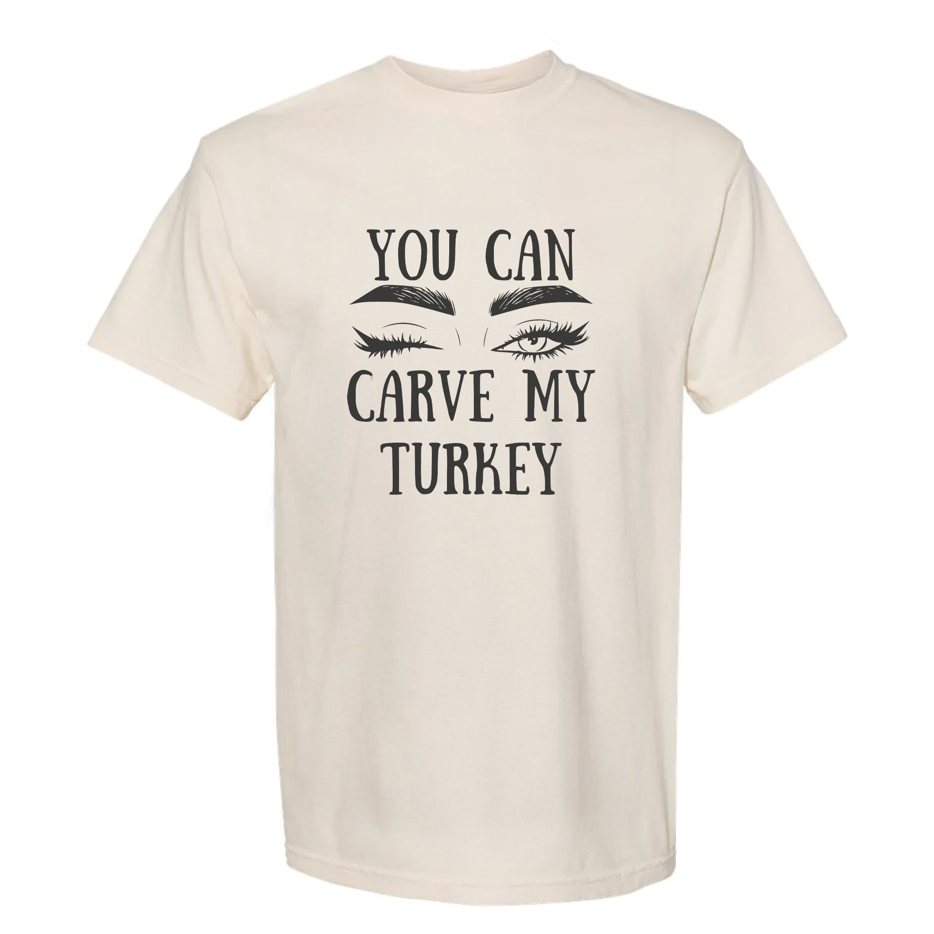 Beige Thanksgiving graphic t-shirt with 'You can carve my Turkey' text and eye makeup graphics on a white background