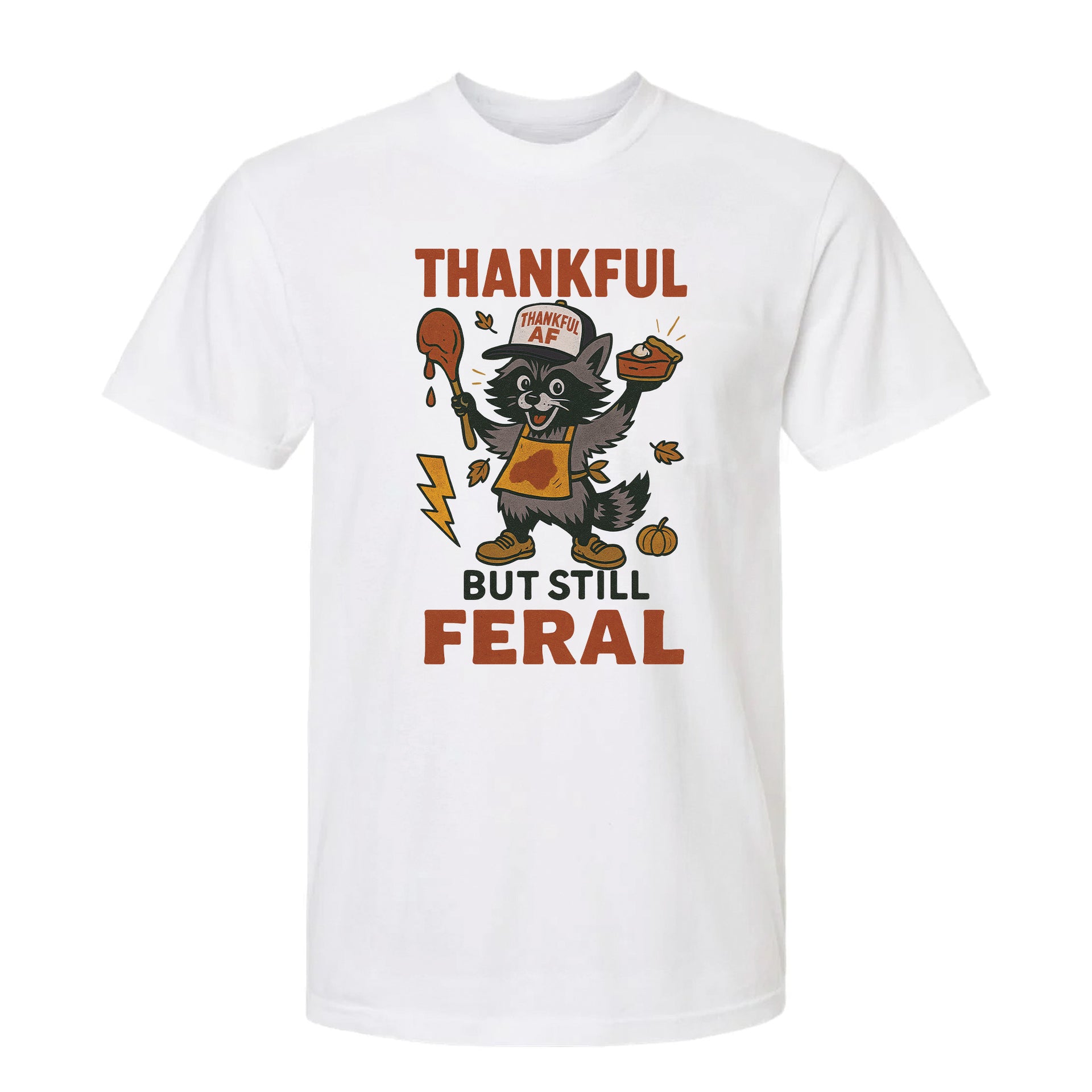 White Thanksgiving graphic t-shirt with text 'Thankful but still feral' on a white background.